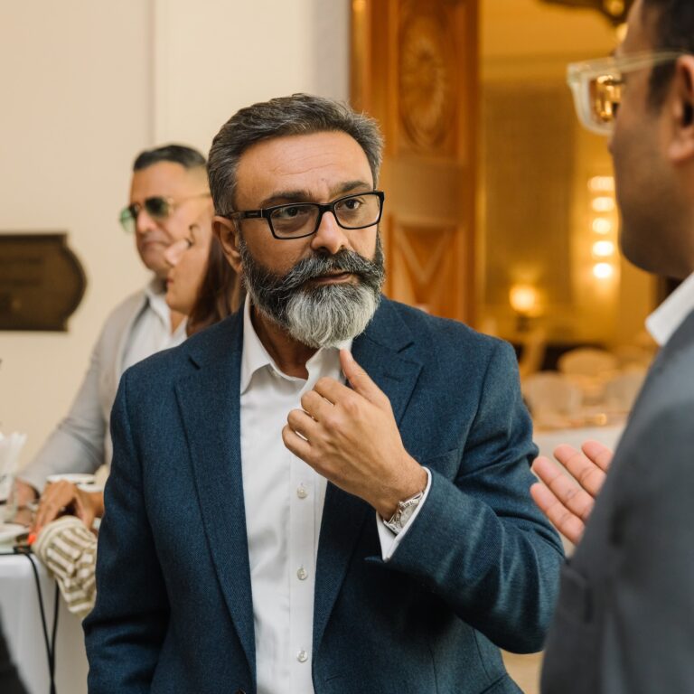 An attendee enjoys connecting with peers at The Syndicate Global luxury networking event held at The One&Only Royal Mirage Dubai.