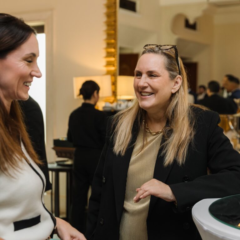 Two attendees engaging in conversation at The Syndicate Global luxury networking event in Dubai
