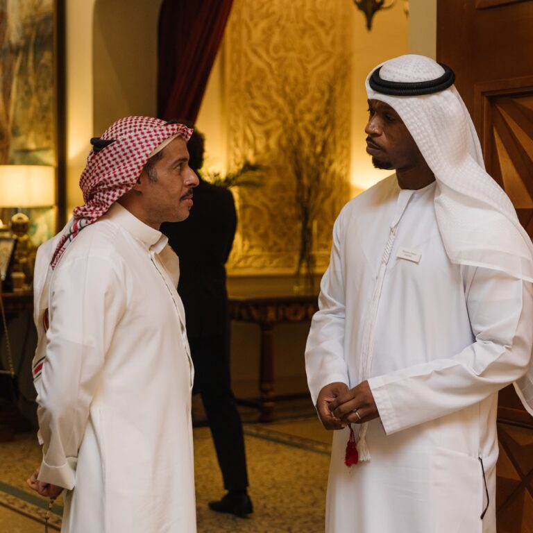 Two attendees engaging in conversation at The Syndicate Global luxury networking event in Dubai