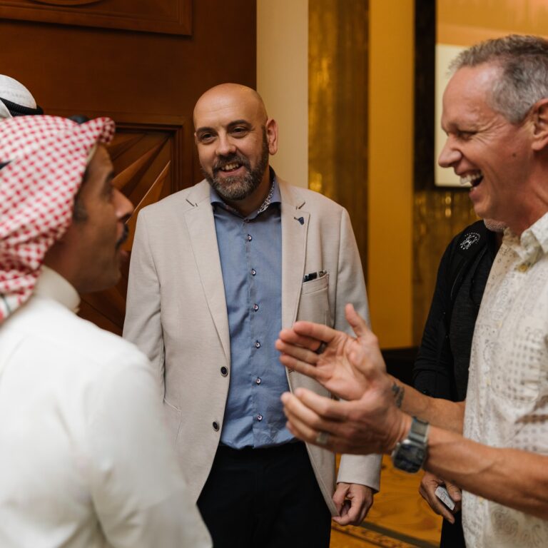 Charlie Engle and Steve Fowles laughing and speaking with attendees at The Syndicate Global luxury event in Dubai