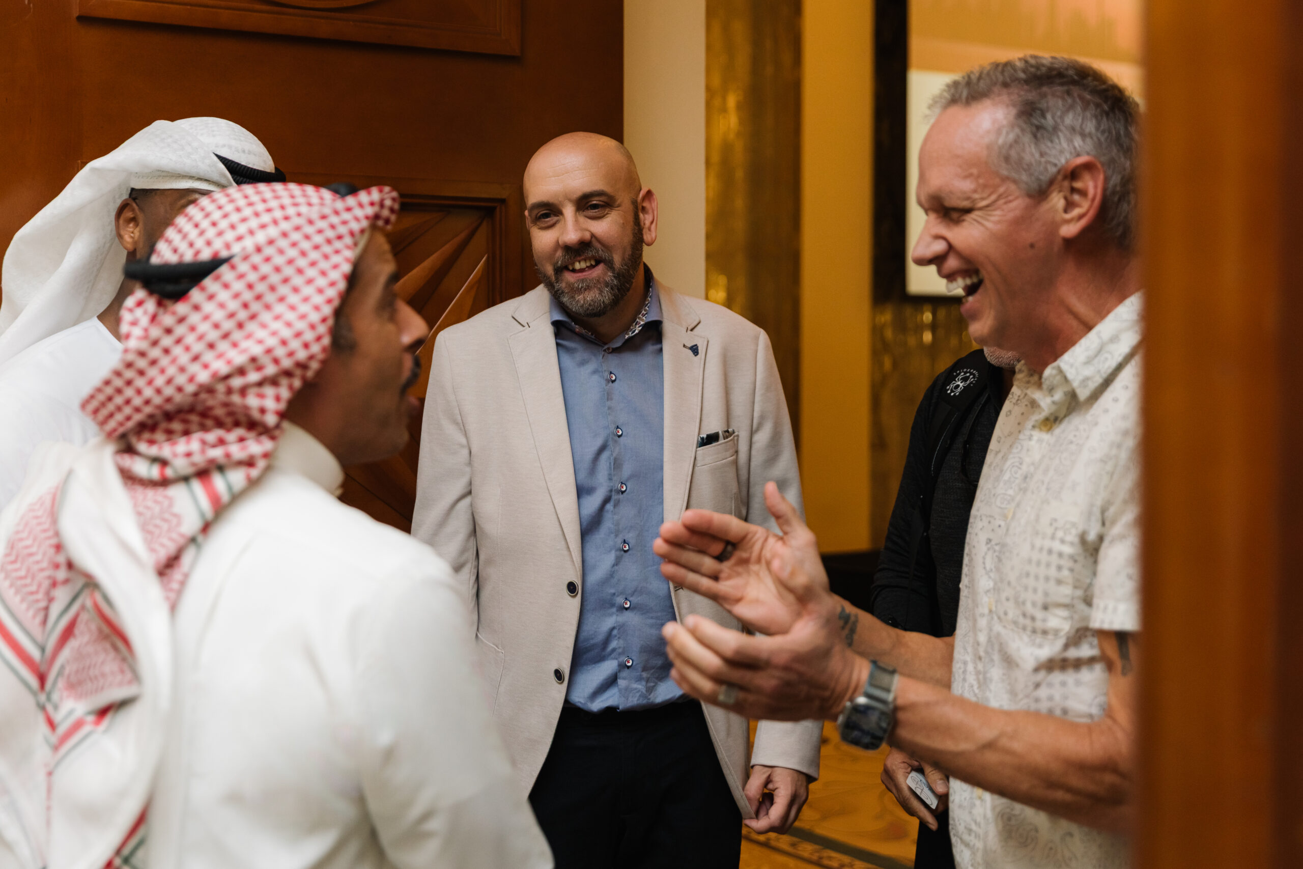 Charlie Engle and Steve Fowles laughing and speaking with attendees at The Syndicate Global luxury event in Dubai