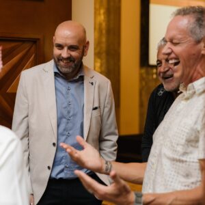 Charlie Engle and Steve Fowles laughing and speaking with attendees at The Syndicate Global luxury event in Dubai