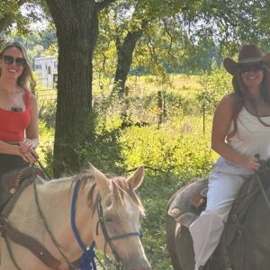 Abigail Horne with a guest enjoying a private ranch tour in Dallas, Texas, as part of a select Syndicate Global member experience, including UHNW founders, family office executives, and business leaders.