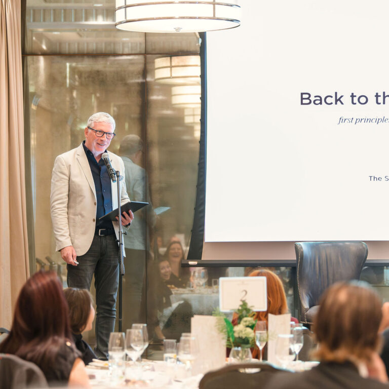 Grant Williams speaking on stage at The Syndicate Global event London, The Connaught