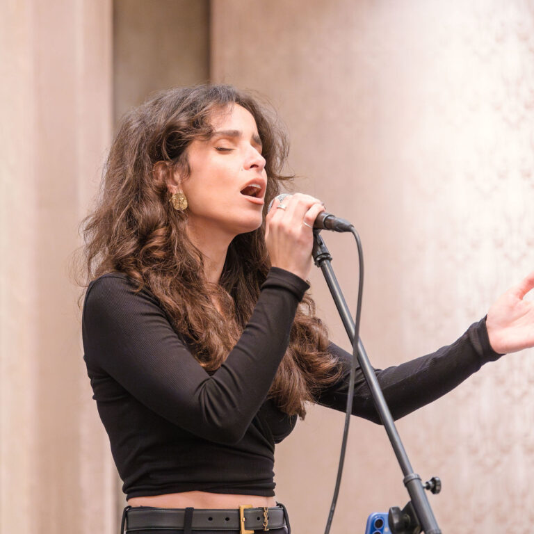 West End singer performing live at The Syndicate Global event at The Connaught, London, entertaining UHNW founders, family offices, and business leaders.